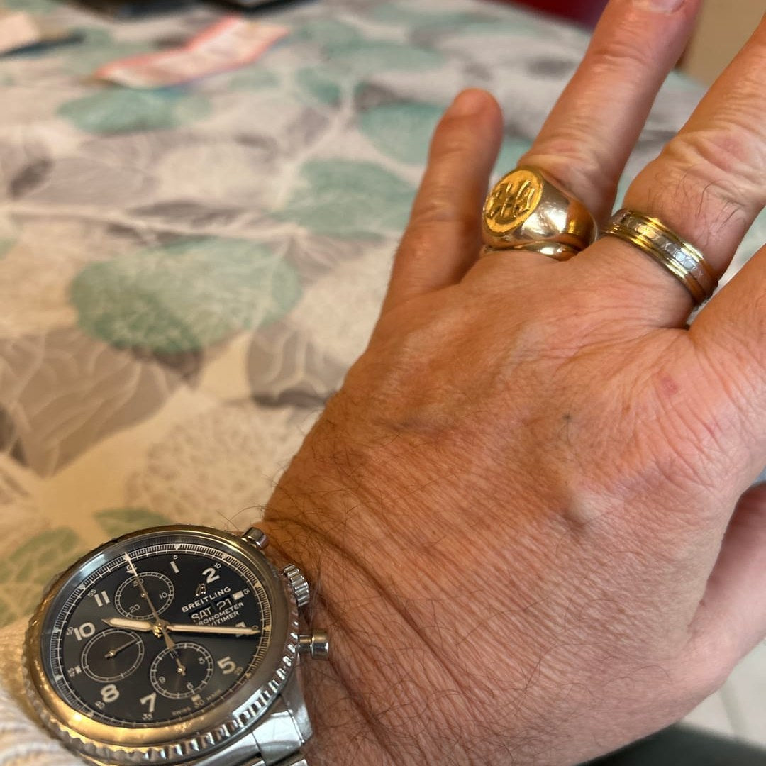 Gold rings and a steel chronograph on a hand, customer photo by Thuilliez E. (sparklean.com review, December 2024)
